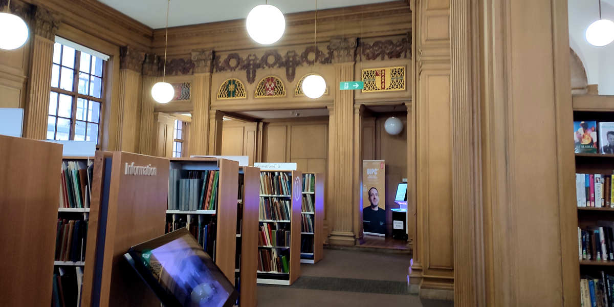 Modern, Ikea-like bookshelves adorn the halls of an ancient library