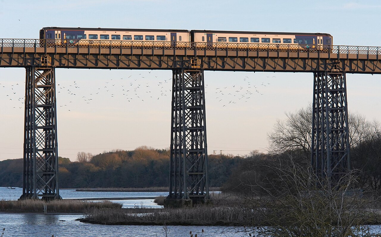 A Northern train crosses a viaduct over the Wansbeck river